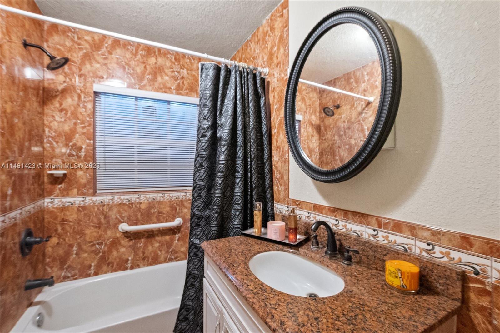 3405 East Shore Road Miramar, FL 33023 - Photo 17 of 25 a bathroom with a granite countertop and a sink