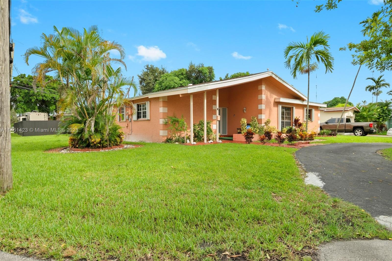 3405 East Shore Road Miramar, FL 33023 - Photo 2 of 25 a front view of house with yard and green space