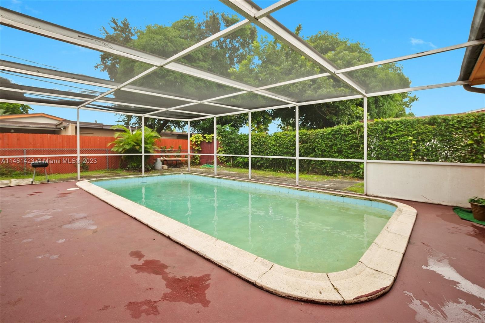 3405 East Shore Road Miramar, FL 33023 - Photo 22 of 25 a view of a backyard with a swimming pool