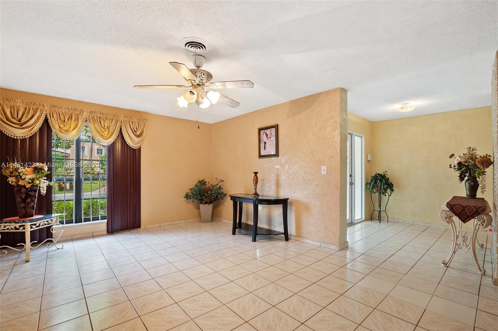 3405 East Shore Road Miramar, FL 33023 - Photo 5 of 25 a view of a livingroom with furniture and a chandelier fan