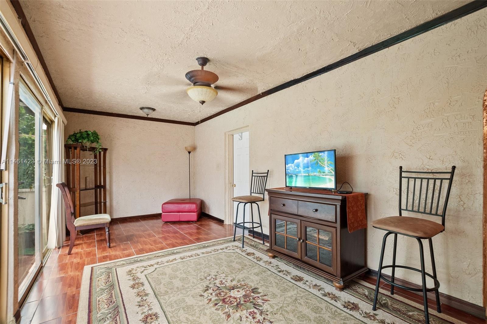 3405 East Shore Road Miramar, FL 33023 - Photo 8 of 25 a living room with furniture and a flat screen tv