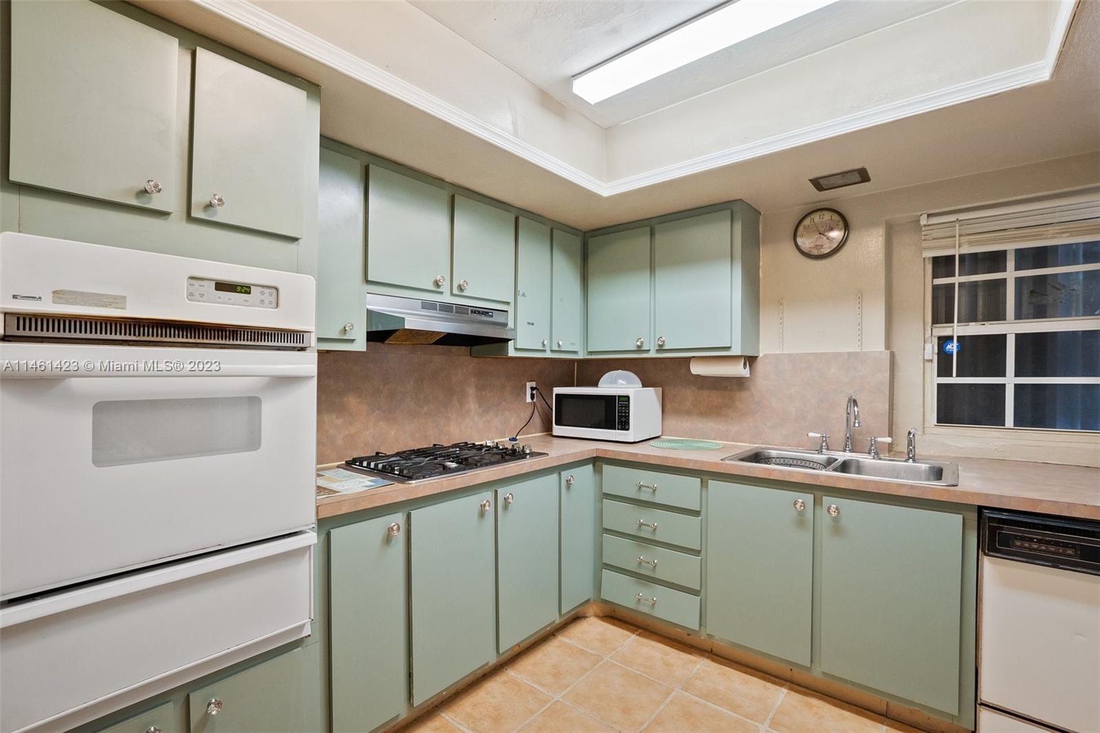 3405 East Shore Road Miramar, FL 33023 - Photo 10 of 25 a kitchen with stainless steel appliances granite countertop a sink stove and cabinets