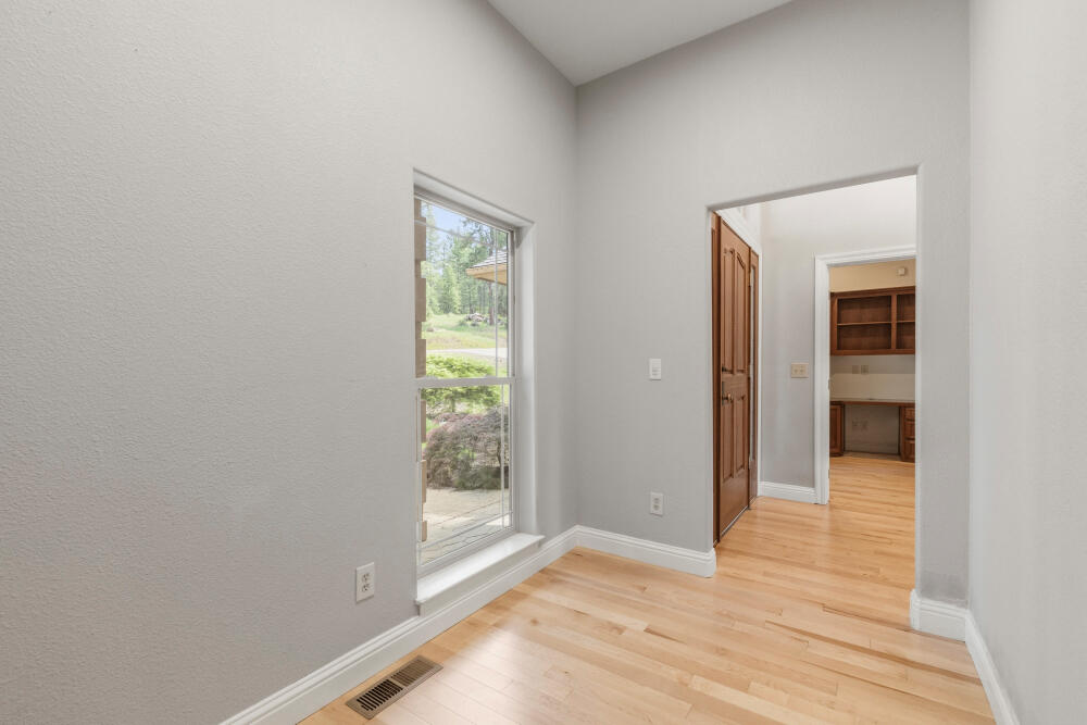 11756 Merganser Road Klamath Falls, OR 97601 - Photo 13 of 73 a view of an empty room with wooden floor and a window
