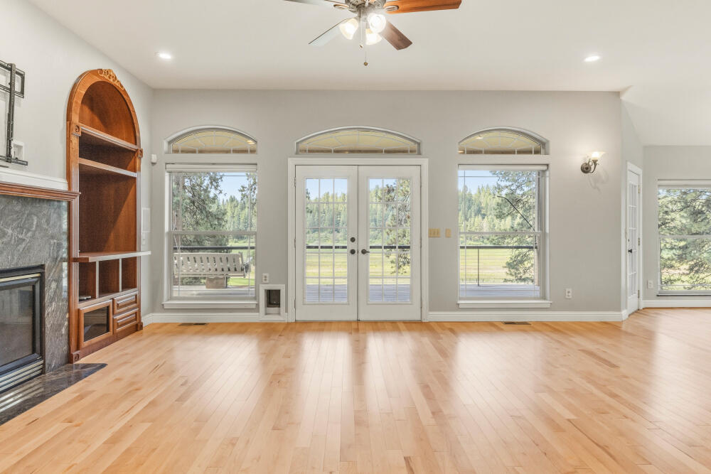 11756 Merganser Road Klamath Falls, OR 97601 - Photo 17 of 73 a view of an empty room with a window and wooden floor