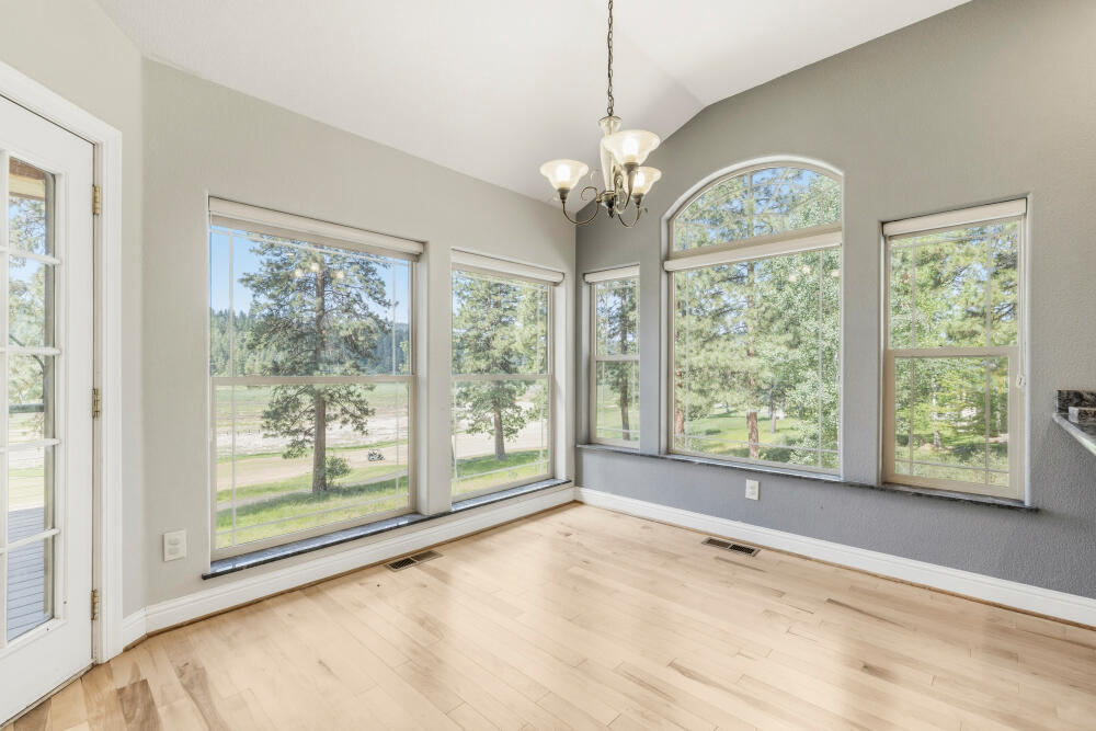 11756 Merganser Road Klamath Falls, OR 97601 - Photo 23 of 73 a view of an empty room with wooden floor and a window