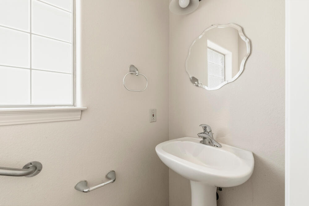 11756 Merganser Road Klamath Falls, OR 97601 - Photo 32 of 73 a bathroom with a sink a mirror and a window