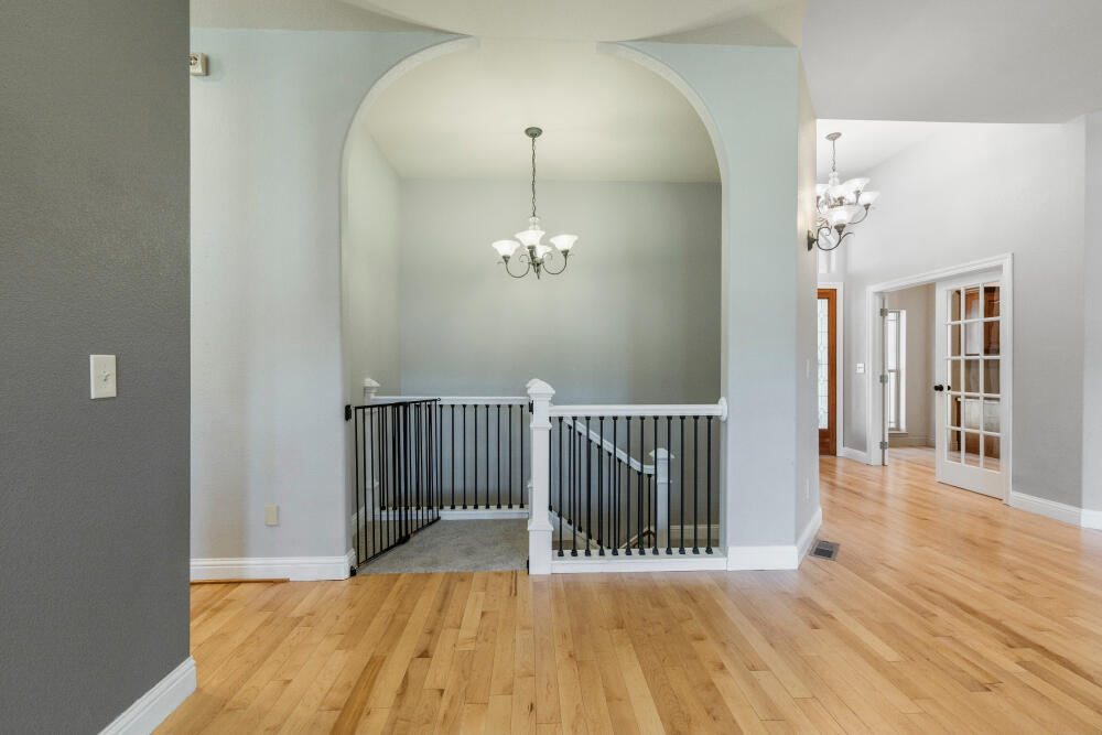 11756 Merganser Road Klamath Falls, OR 97601 - Photo 48 of 73 a view of a hallway with wooden floor and a chandelier
