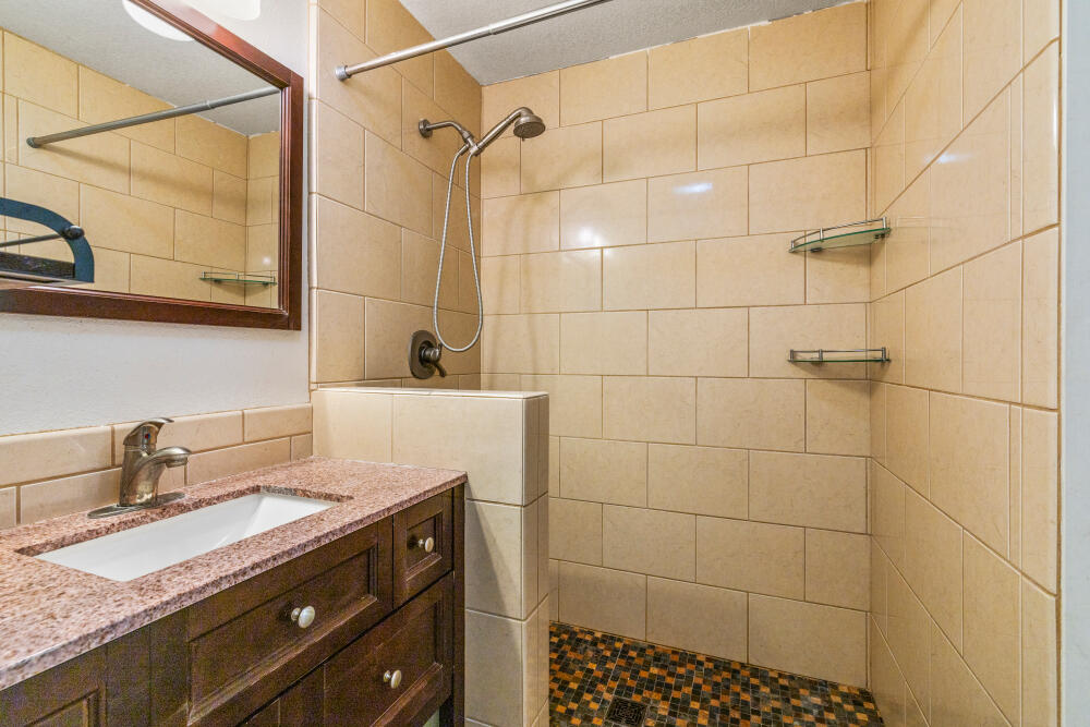 11756 Merganser Road Klamath Falls, OR 97601 - Photo 59 of 73 a bathroom with a granite countertop sink a mirror and shower