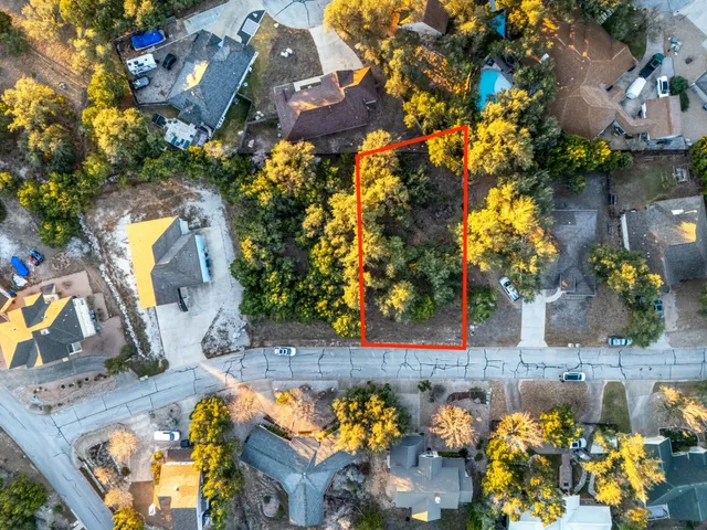 an aerial view of a house with a yard and swimming pool
