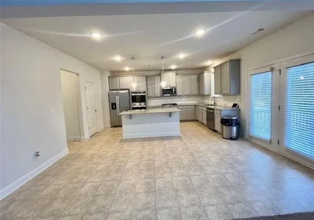 a view of a kitchen with a sink and cabinets