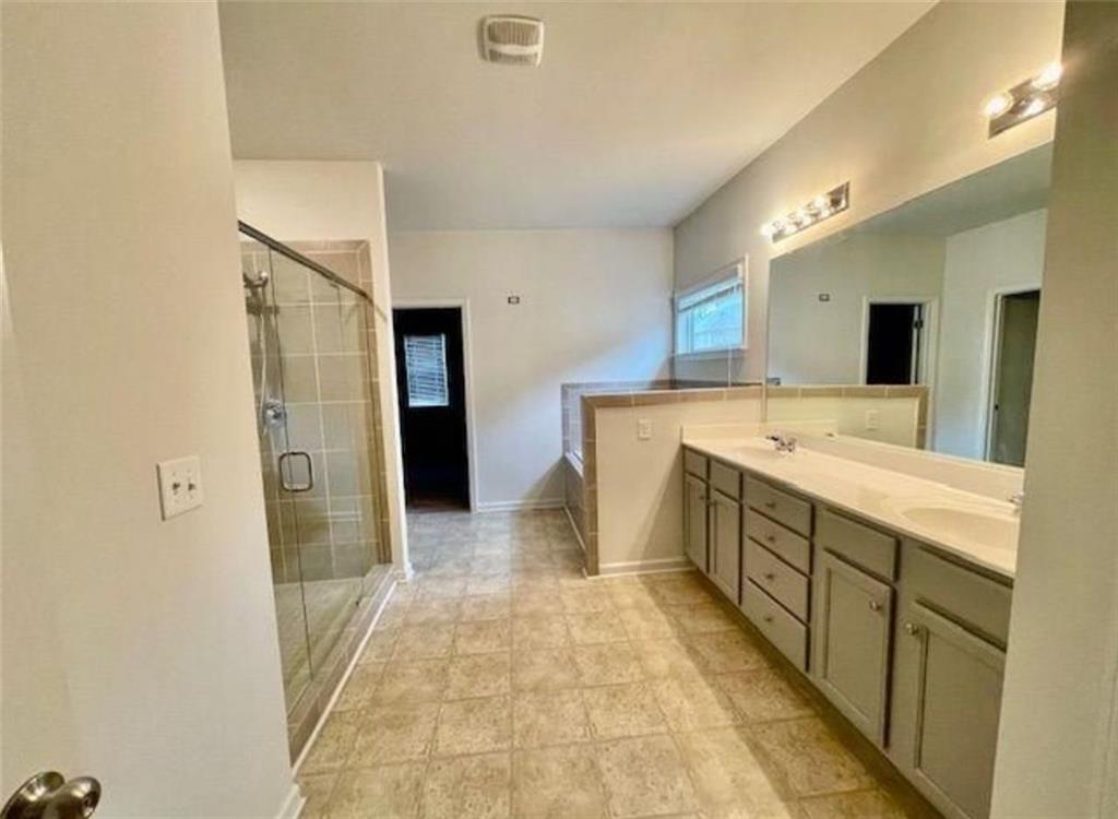 181 Charolais Drive McDonough, GA 30252 - Photo 19 of 25 a spacious bathroom with a sink and a mirror