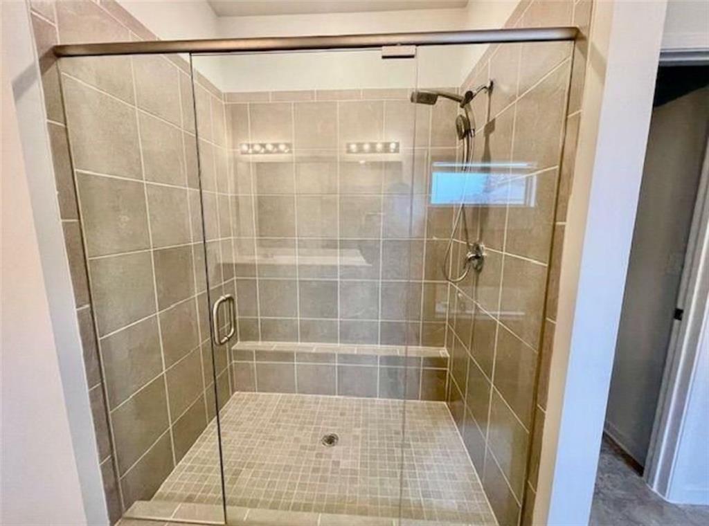 181 Charolais Drive McDonough, GA 30252 - Photo 20 of 25 a bathroom with a shower and a glass door