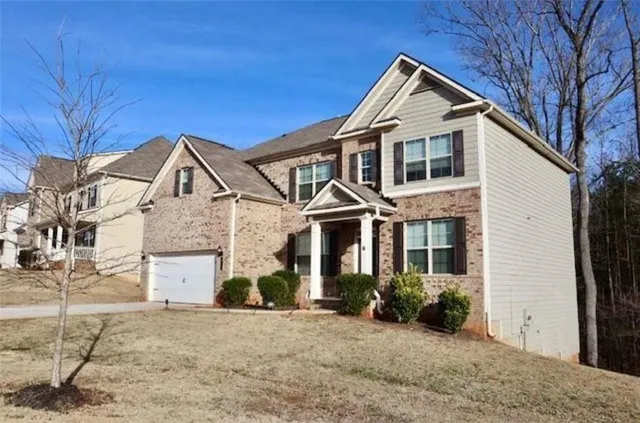a front view of a house with a yard