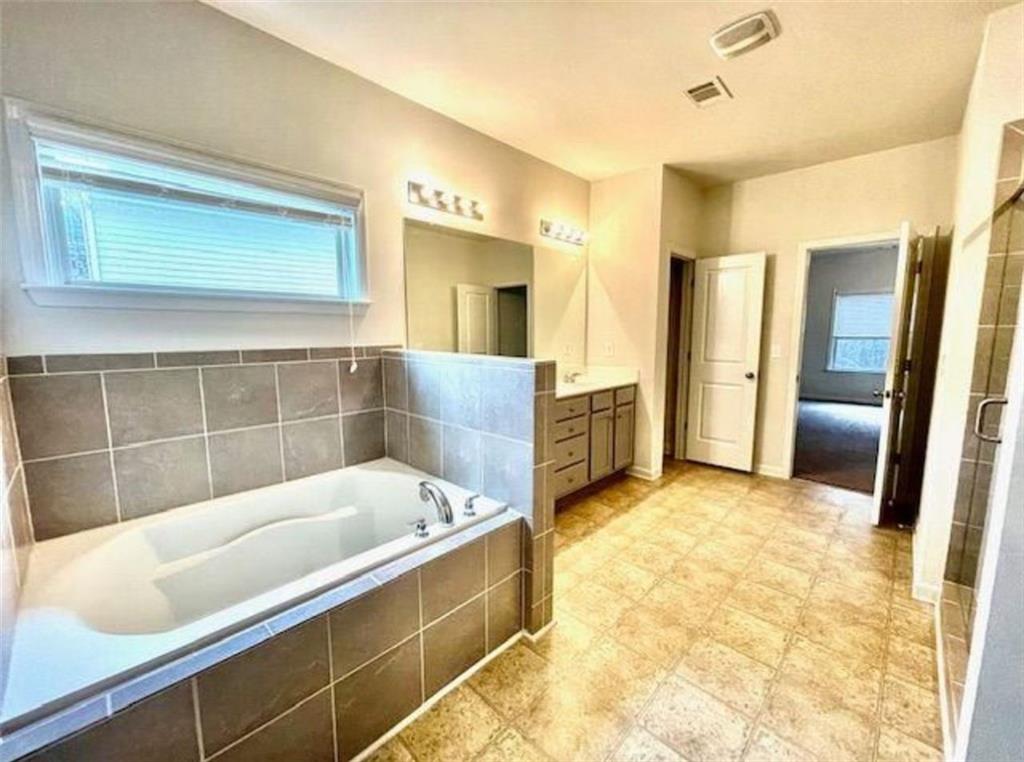 181 Charolais Drive McDonough, GA 30252 - Photo 21 of 25 a bathroom with a tub a sink and a shower