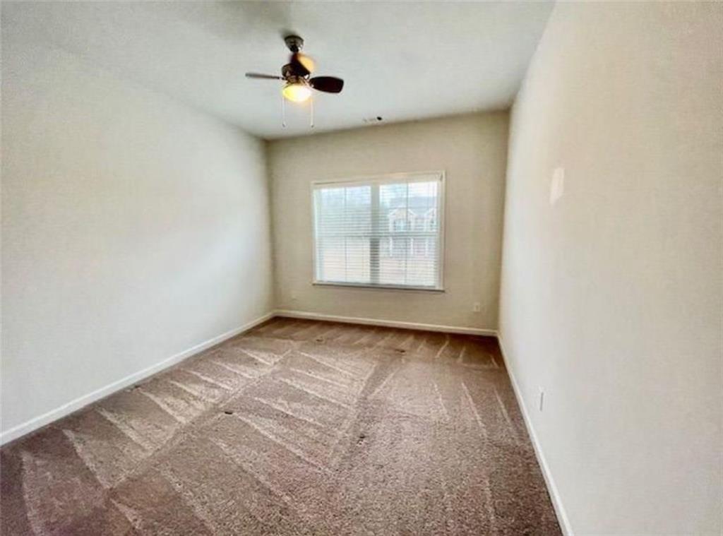 181 Charolais Drive McDonough, GA 30252 - Photo 23 of 25 an empty room with windows and fan