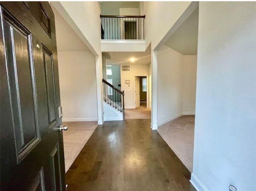 181 Charolais Drive McDonough, GA 30252 - Photo 3 of 25 a view of a hallway with wooden floor and staircase