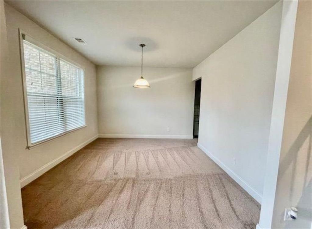 181 Charolais Drive McDonough, GA 30252 - Photo 4 of 25 an empty room with wooden floor and windows