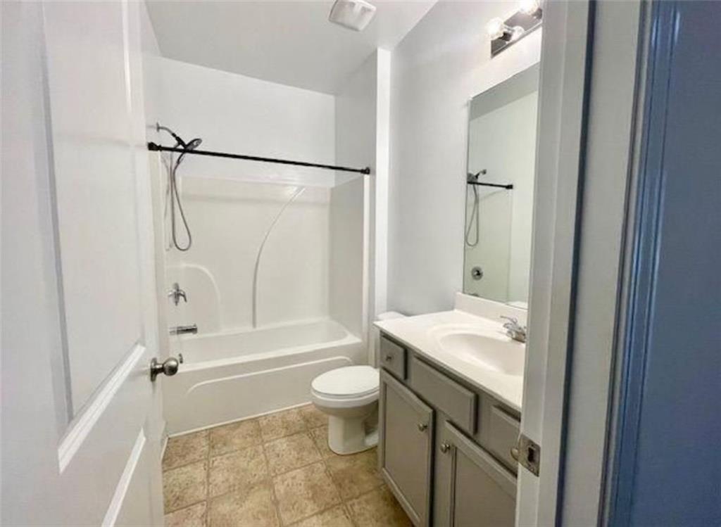 181 Charolais Drive McDonough, GA 30252 - Photo 7 of 25 a bathroom with a granite countertop sink toilet and shower