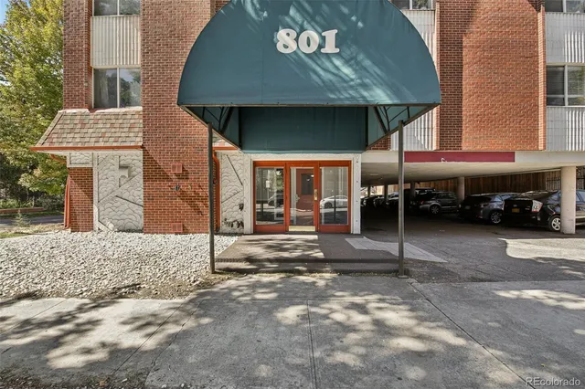 a view of a house with parking space and a car parked in front of it
