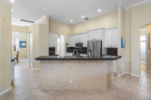 a kitchen with stainless steel appliances granite countertop a refrigerator and a sink