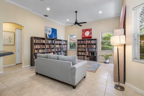 a living room with furniture a rug and a bookshelf
