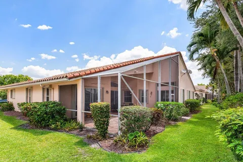 a front view of house with a garden
