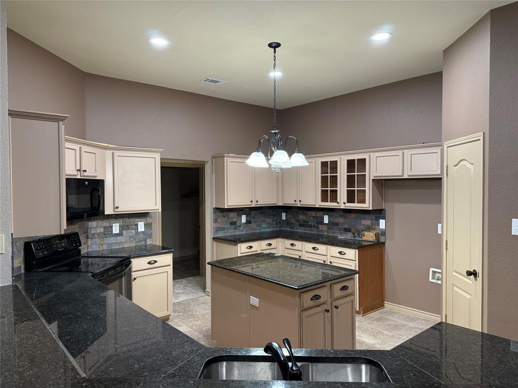 3624 Big Horn Trail Denton, TX 76210 - Photo 2 of 10 a kitchen with stainless steel appliances granite countertop a stove a sink dishwasher a refrigerator white cabinets and wooden floor