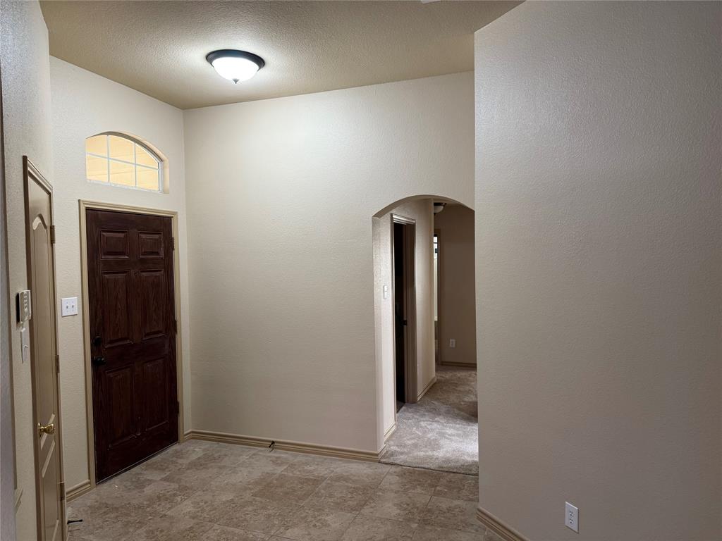 3624 Big Horn Trail Denton, TX 76210 - Photo 6 of 10 an empty room with window and mirror