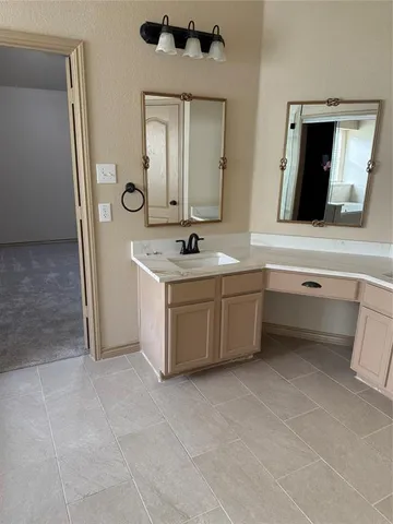 a bathroom with a sink vanity and mirror