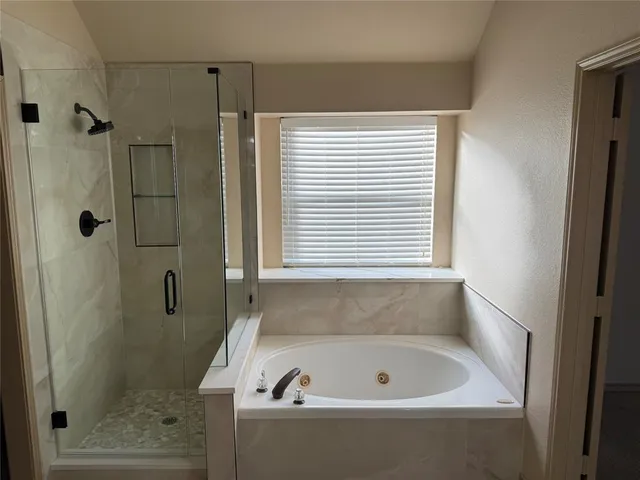 a bathroom with a bathtub and a shower