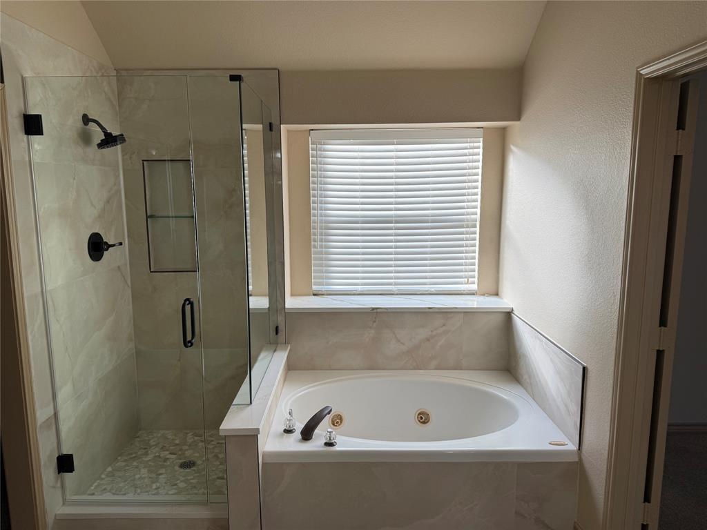 3624 Big Horn Trail Denton, TX 76210 - Photo 10 of 10 a bathroom with a bathtub and a shower