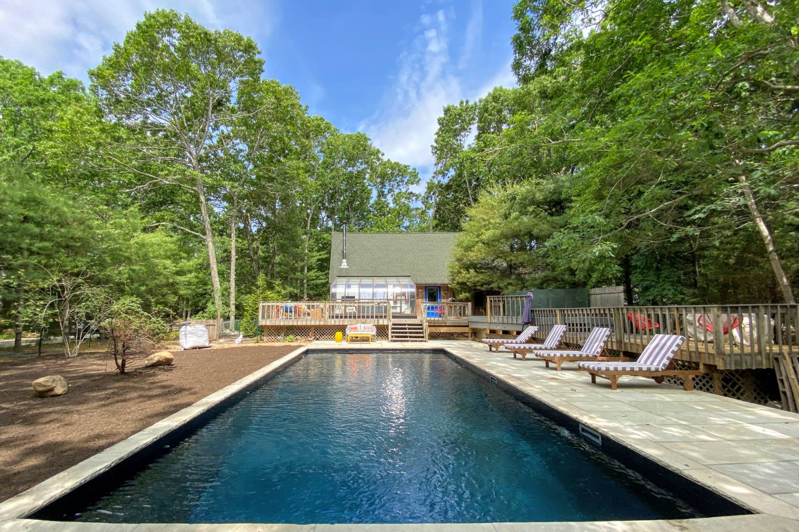 swimming pool view with a seating space