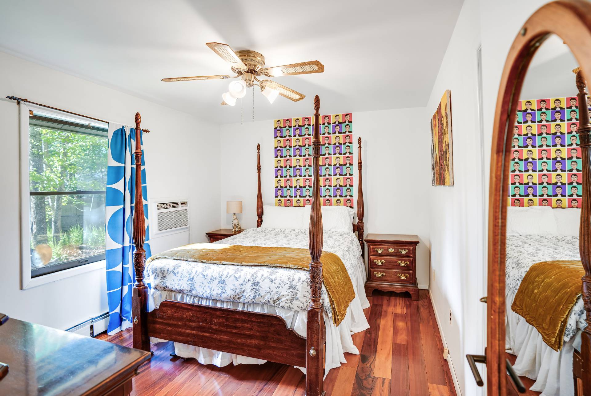 62 Broadway East Hampton, NY 11937 - Photo 12 of 20 a bedroom with a bed window and a chandelier