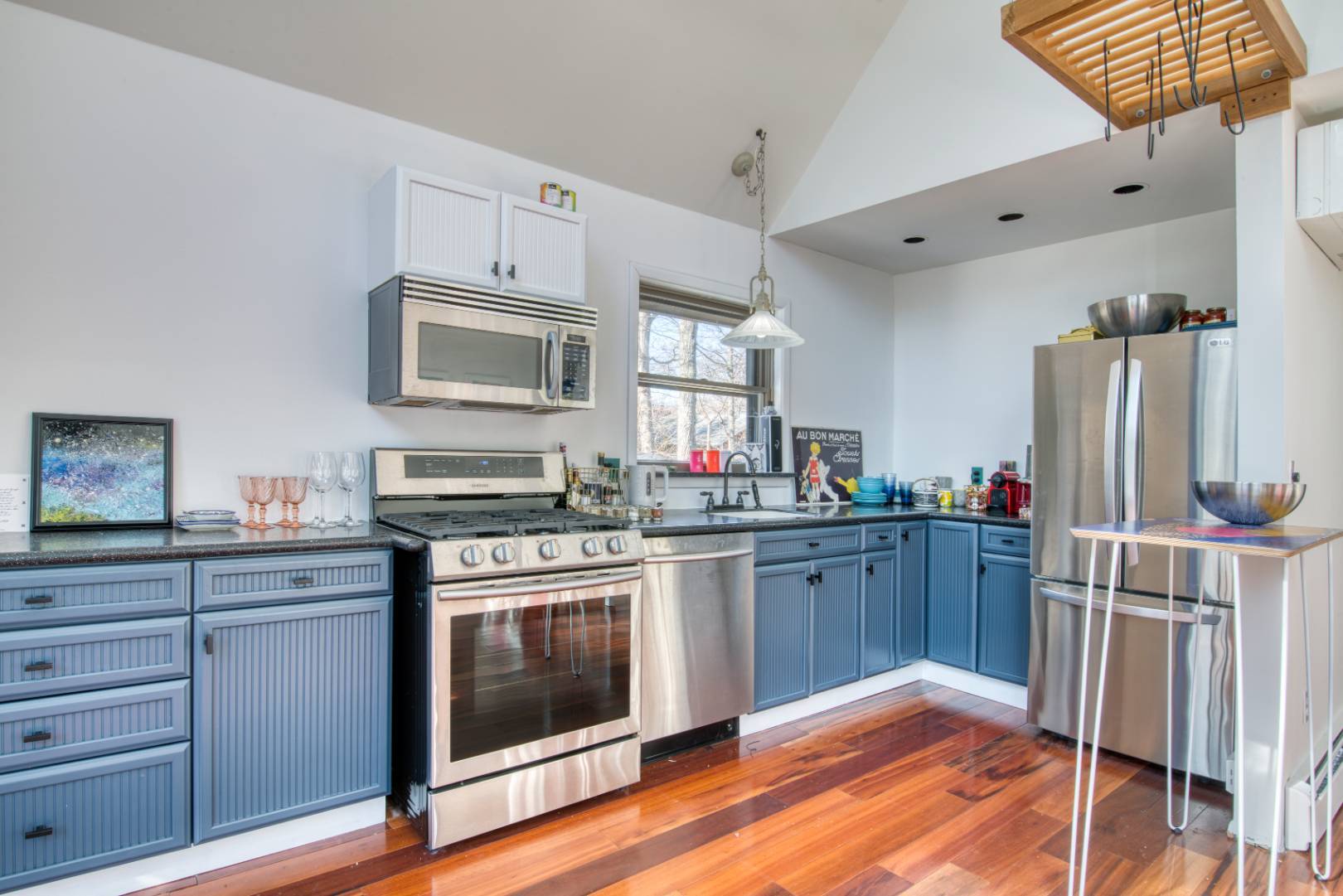 62 Broadway East Hampton, NY 11937 - Photo 8 of 20 a kitchen with stainless steel appliances granite countertop a stove cabinets and wooden floor