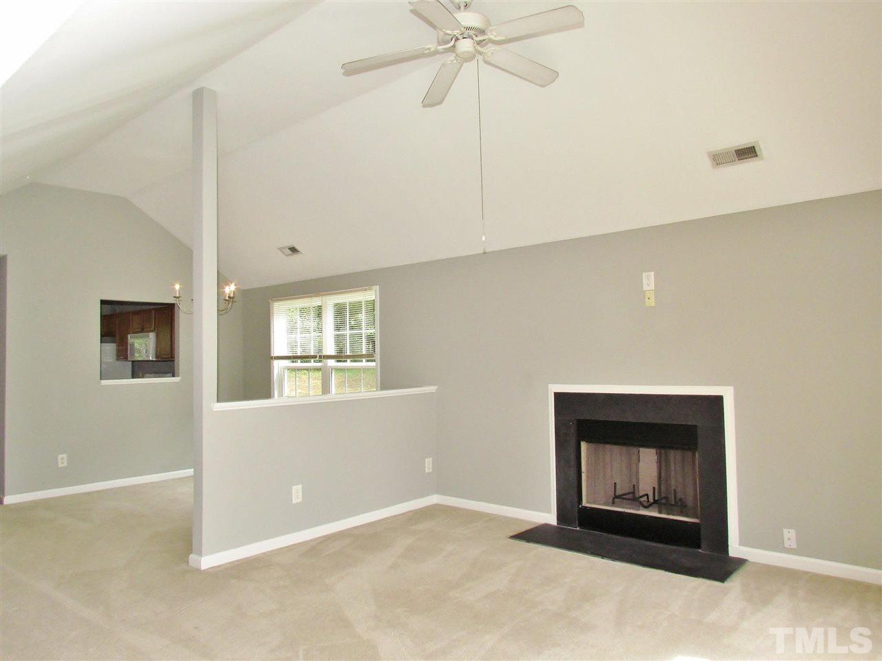905 Roxy Street Raleigh, NC 27610 - Photo 4 of 30 an empty room with windows and fireplace