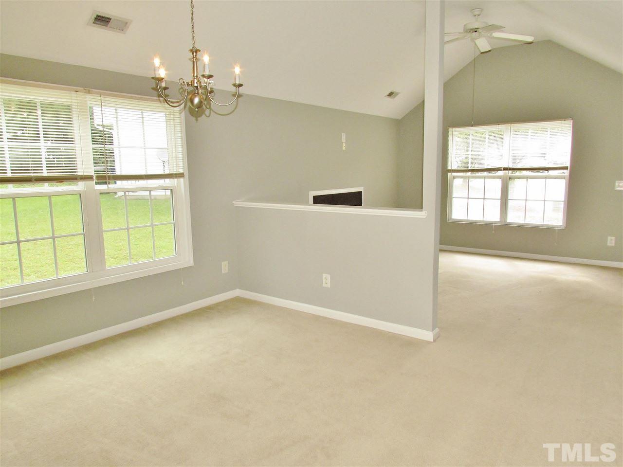 905 Roxy Street Raleigh, NC 27610 - Photo 8 of 30 an empty room with chandelier fan and windows