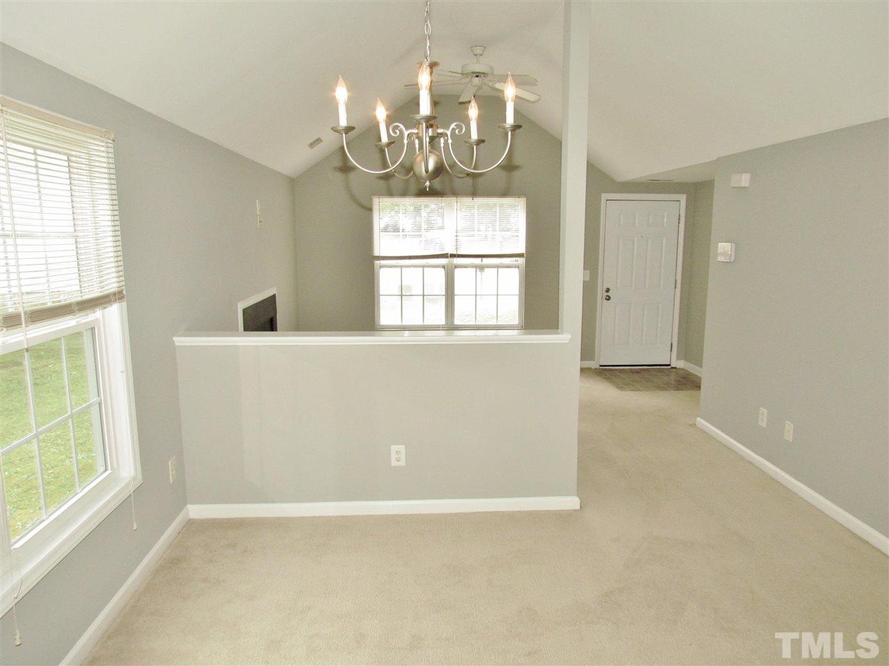 905 Roxy Street Raleigh, NC 27610 - Photo 9 of 30 an empty room with chandelier fan and windows