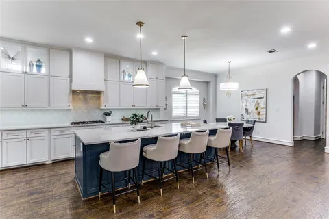 a large kitchen with a table and chairs