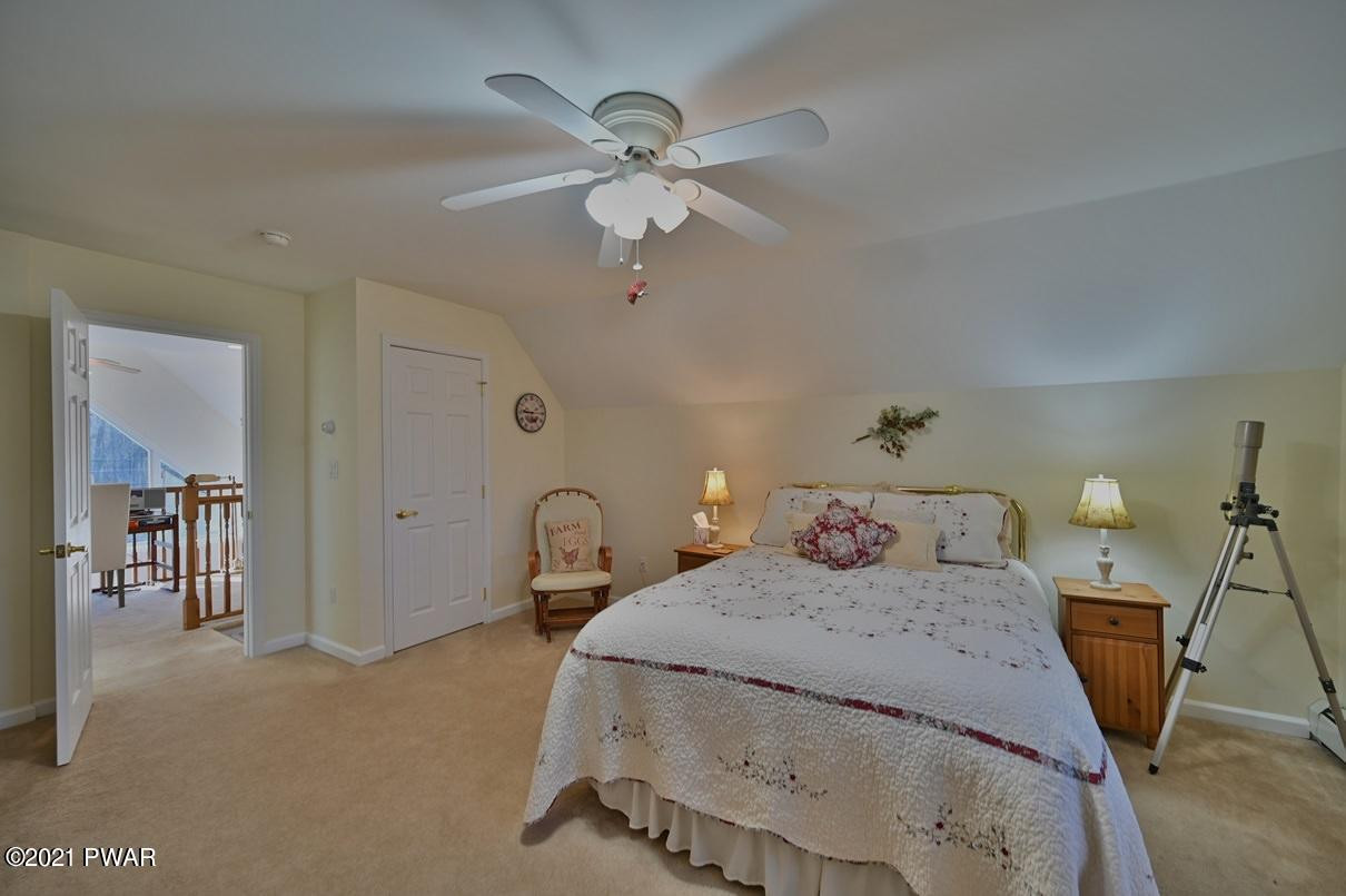 76 Rockway Road Lake Ariel, PA 18436 - Photo 50 of 101 a bedroom with a bed and a chandelier
