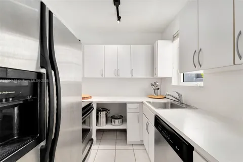 a kitchen with sink cabinets and appliances