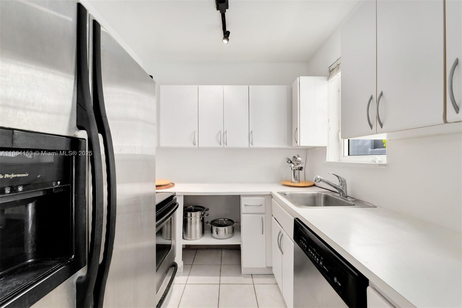 1018 Meridian Avenue, Unit 8 Miami Beach, FL 33139 - Photo 11 of 12 a kitchen with a sink appliances and cabinets
