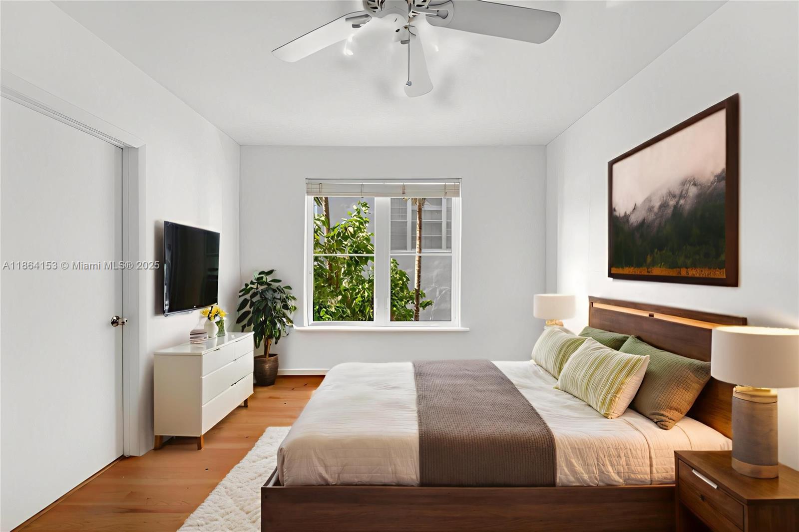 1018 Meridian Avenue, Unit 8 Miami Beach, FL 33139 - Photo 3 of 12 a bedroom with a bed and a flat screen tv