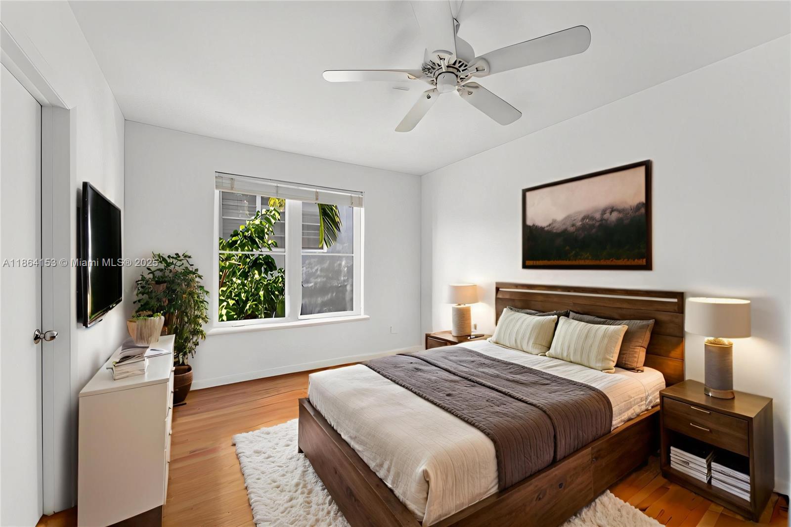 1018 Meridian Avenue, Unit 8 Miami Beach, FL 33139 - Photo 4 of 12 a bedroom with a large bed tv and a window