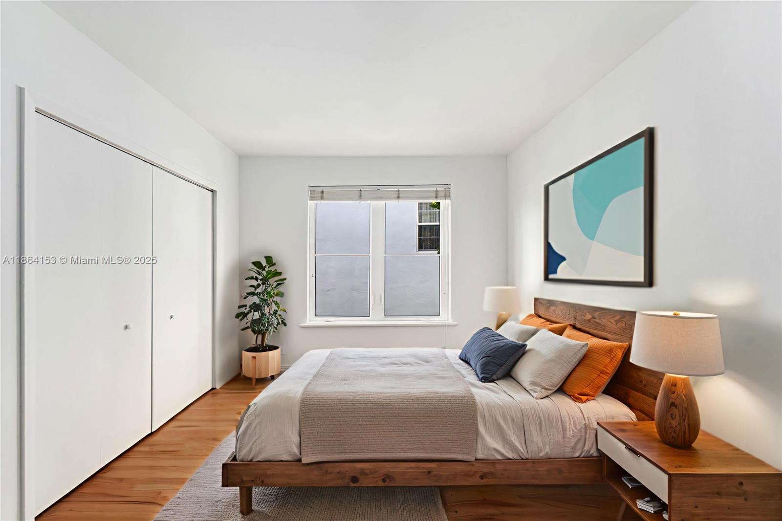 1018 Meridian Avenue, Unit 8 Miami Beach, FL 33139 - Photo 6 of 12 a bedroom with a bed and lamp