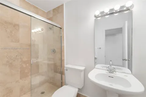 a bathroom with a sink toilet and shower