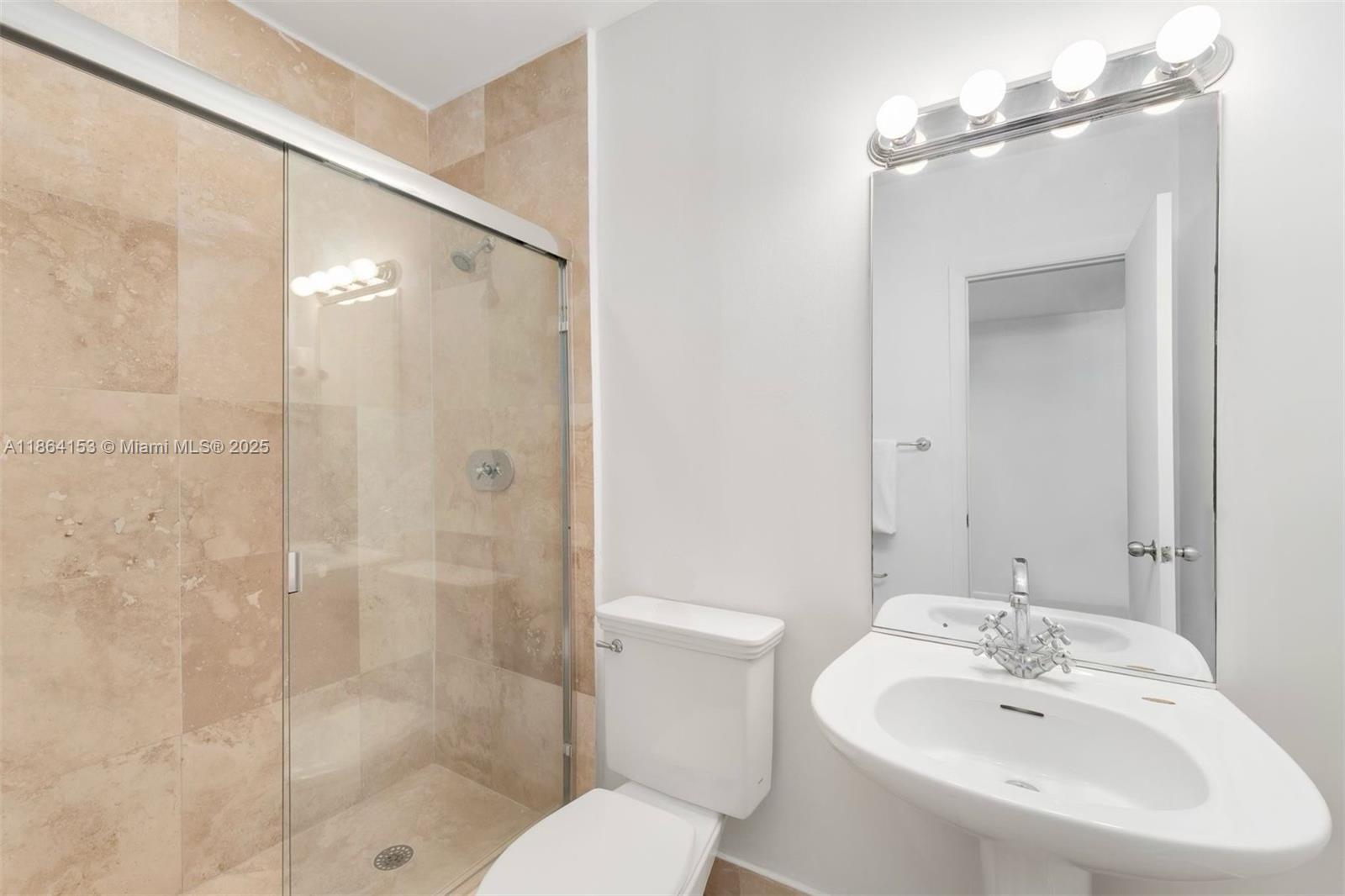 1018 Meridian Avenue, Unit 8 Miami Beach, FL 33139 - Photo 8 of 12 a bathroom with a sink toilet and shower