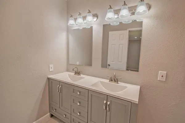 a bathroom with a sink double vanity and a mirror