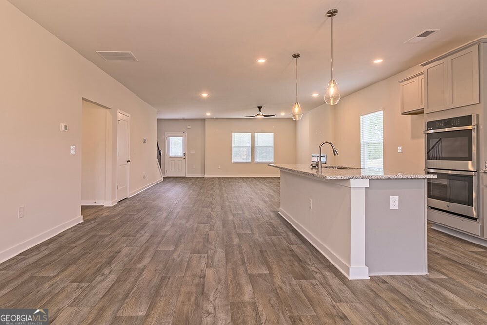 148 Post Oak Drive, Unit 139 Jackson, GA 30233 - Photo 11 of 24 a view of a kitchen with kitchen island a counter top space a sink and stainless steel appliances