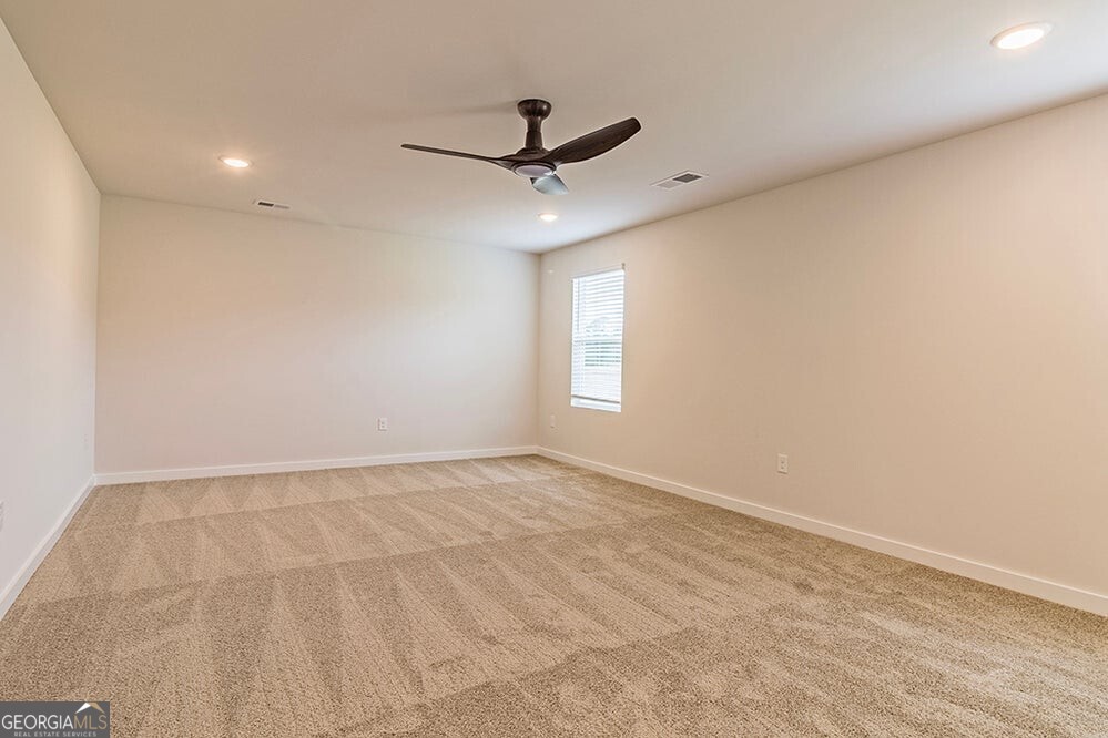 148 Post Oak Drive, Unit 139 Jackson, GA 30233 - Photo 13 of 24 an empty room with a window and a fan