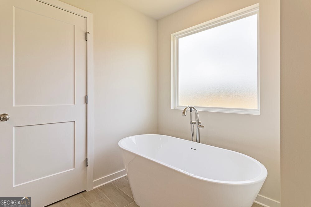148 Post Oak Drive, Unit 139 Jackson, GA 30233 - Photo 16 of 24 a white bath tub sitting next to a white sink